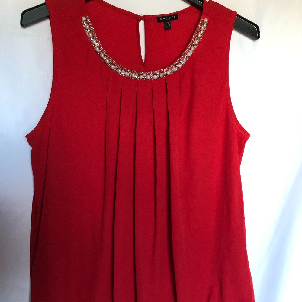 Red blouse with pearl accents
